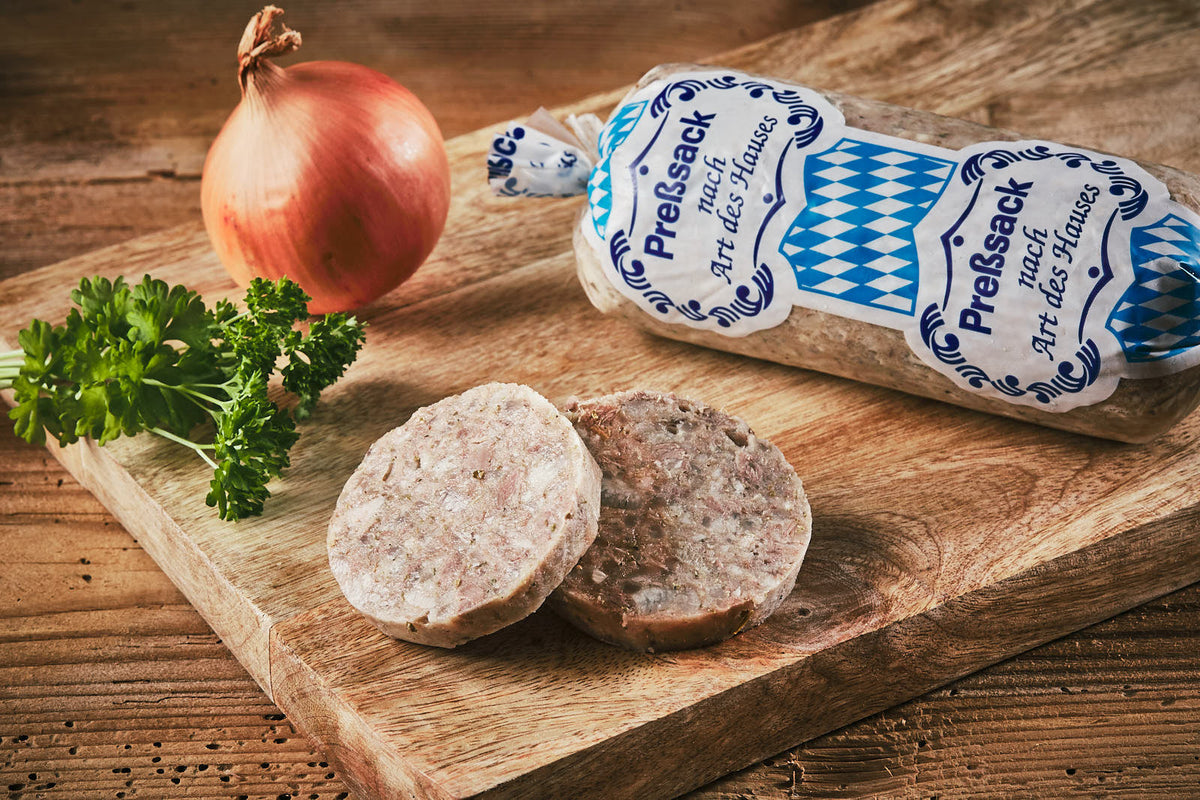 Auf dem Bild ist Land.Luft Pressack Weiß in Bio-Qualität zu sehen – eine herzhafte Wurstspezialität, ideal für Brotzeit, Brotbelag oder Wurstplatten. Jetzt bequem online kaufen und bestellen.